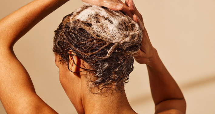 woman washing hair silicone-free shampoo