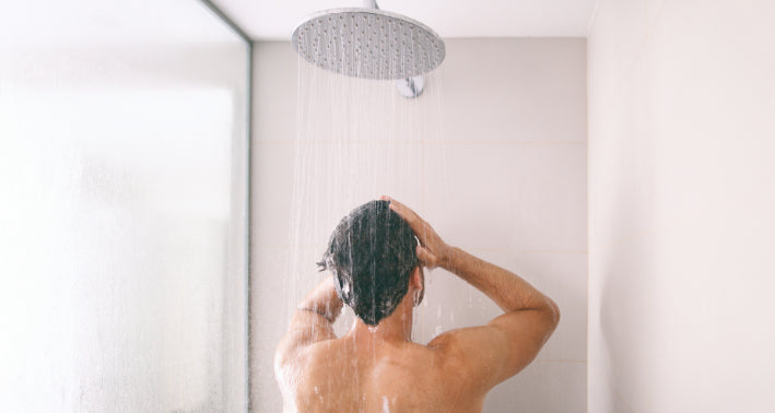 man washing his body with ph neutral shower gel