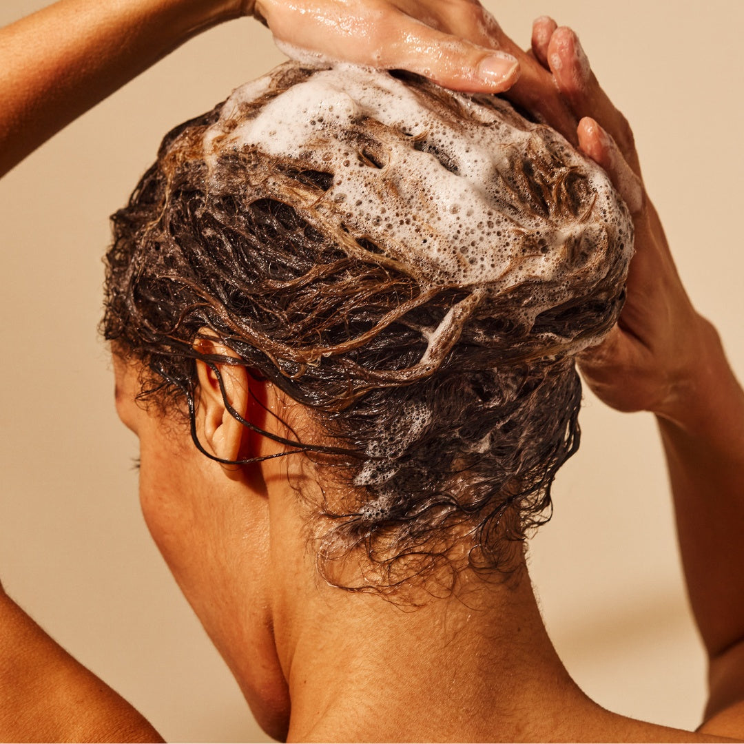 girl washing her hair with less is more shampoo